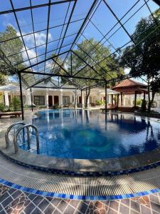 a large swimming pool with a glass ceiling at Kim Xuan Bungalow in Phu Quoc