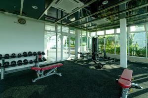 a room with a gym with dumbbells and a bench at Sutera Avenue KK Infinity Pool 10 mins to Airport 10 mins to Jetty LSS HomeStay in Kota Kinabalu