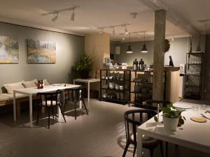 a room with tables and chairs and a couch at Stilleben Hotell in Åmot