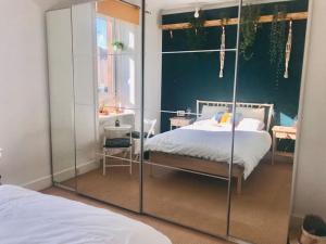 a bedroom with a bed and a glass wall at Cosy 2 Bedroom Flat in Edinburgh in Edinburgh