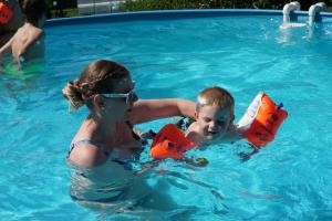 a woman and a child playing in a swimming pool at Familienbauernhof Salmanner in Steinbach an der Steyr