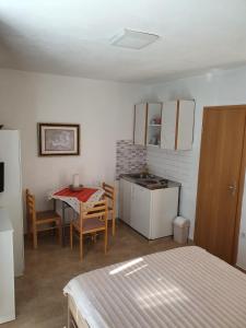 a room with a kitchen and a table with a tableablish at Villa Ilona in Primošten