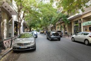 a street with cars parked on the side of the road at Valaoritou Boutique Apartment,Kolonaki in Athens