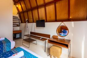 a room with a bed and a desk with a mirror at Omah Lumbung Yogyakarta in Seturan