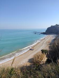 a beach with people on the sand and the ocean at Casa LOLU in Ortona