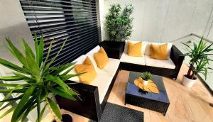 einen Balkon mit Sofas und Topfpflanzen in der Unterkunft Nobless Apartments Holedná Brno in Brünn