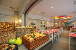 a restaurant with tables and chairs and baskets of food at Floreal La Roche-en-Ardenne in La-Roche-en-Ardenne