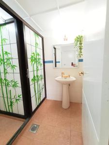 a bathroom with a sink and a mirror at Apartment Islam Bayu Beach PD in Port Dickson