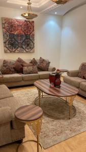 a living room with couches and a coffee table at Strings Chalet in Riyadh