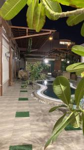 a swimming pool in a building with plants at Strings Chalet in Riyadh