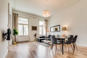 un soggiorno con tavolo, sedie e divano di Charles Bridge - 3 bedroom Apartment - Old Town a Praga