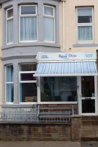 a shop with awning in front of a building at Briny View Hotel in Blackpool