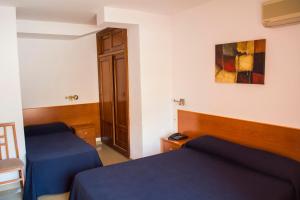 Postel nebo postele na pokoji v ubytování Hotel L'Escala