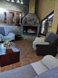 a living room with two beds and a fireplace at Cal Pes De Tendrui in Las Bordas