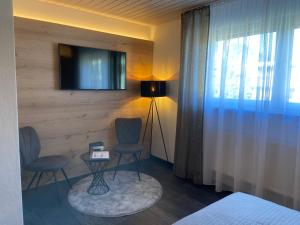 TV a/nebo společenská místnost v ubytování Hotel Koch