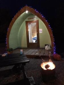 an arched doorway to a house with a fire pit at East Coast Adventure Centre Glamping in Rostrevor