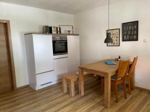 a kitchen and dining room with a table and a refrigerator at Ferienwohnung Wässerndorf in Wässerndorf