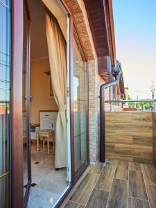 an open door of a house with a balcony at Guest house Nikolaevsky in Bilhorod-Dnistrovskyi