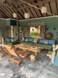 a living room with a couch and a dog laying on the floor at Villa Anjing in Nusa Dua