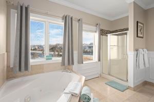 a large bathroom with a tub and a window at The Beacon Waterfront Inn in Hull