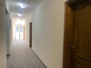 un corridoio vuoto con una porta e una stanza con una finestra di LOTUS ALMANSOURi لوتس المنصوري a Kruščica