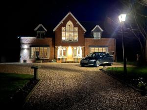 a car parked in front of a house at night at Martlets B&B in Shanklin