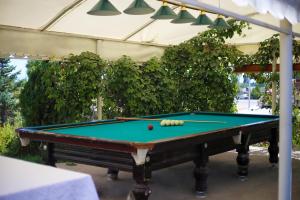 a pool table with a ball on top of it at Aquamarine Inn in Cholpon-Ata