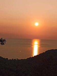 a sunset over the ocean with the sun in the sky at VIEW Apartment LUKOVE in Lukovë