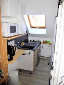 a small kitchen with a sink and a microwave at sérénite normande in Bolbec