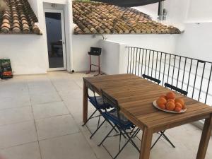 - une table en bois avec un bol d'oranges dans l'établissement "Aqui se vive bien", à Burriana