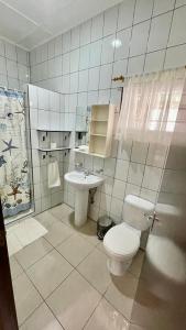 a bathroom with a toilet and a sink at Roche Kerlan Apartments in Praslin