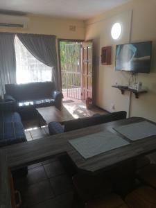 a living room with a couch and a table at St Lucia Villa Mia 8 in St Lucia