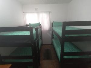 a bedroom with two bunk beds and a window at St Lucia Villa Mia 8 in St Lucia
