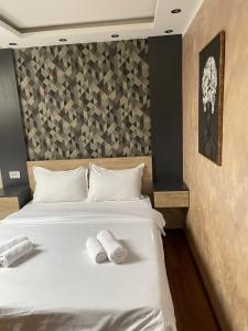 a bedroom with a bed with two towels on it at Apartmani Mali vikend in Belgrade +7 photos