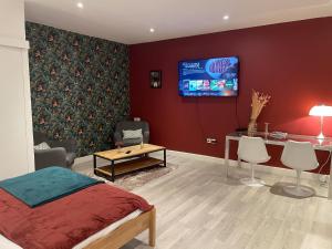 a bedroom with a bed and a tv on a wall at Le Relais Du Petit Lion in Blois