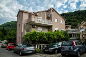 a building with cars parked in front of it at Apartments Kordic in Budva