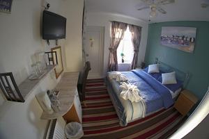 a bedroom with a blue bed and a window at The Eastleigh in Skegness