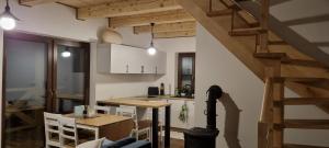 a kitchen with a table and a dining room at Leśniczówka Kalina in Wetlina