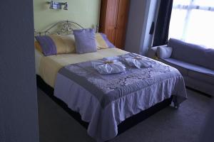 a bedroom with a bed with two towels on it at The Eastleigh in Skegness