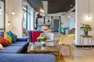 a living room with couches and chairs and a table at Campanile Epinal Centre - Gare in Épinal