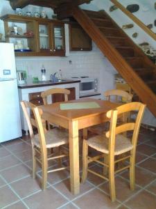 a kitchen with a wooden table and four chairs at Villa Panayiota in Alonnisos +18 photos
