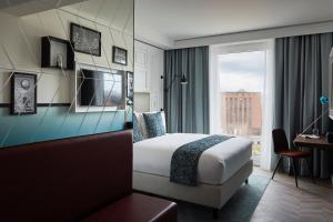 a hotel room with a bed and a window at Hotel Indigo Dresden - Wettiner Platz by IHG in Dresden +37 photos