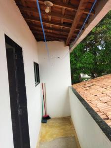a room with a white wall and a wooden ceiling at Apartamento in São José da Coroa Grande +8 photos