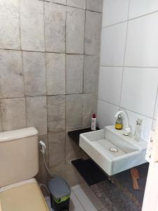 a bathroom with a sink and a toilet at Apartamento in São José da Coroa Grande