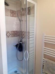 a shower with a glass door in a bathroom at Maison charmante à Saint-Blimont avec jardin in Saint-Blimont +18 photos