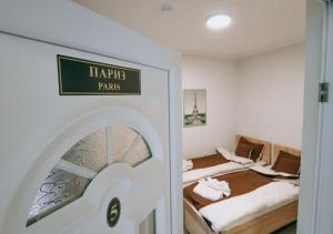a room with two beds and a sign on the door at Vila EVROPA in Sombor