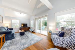 a living room with two couches and a tv at Ferry Harbor Cottage in Falmouth