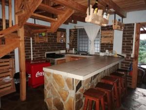 a kitchen with a large stone counter in a room at Cabañas San José de la Montaña in Mazamitla