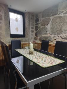 a dining room with a table with a candle on it at O Recuncho do Maio in Muros