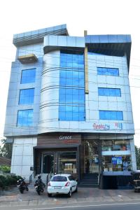 a building with a car parked in front of it at GRACE RESIDENCY in Tirūr
